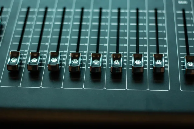 fader, volume control, audio mixer, console, control panel, mixing console, studio mixer, music, sound, audio, device, closeup. How long does podcast episode editing take in the US?