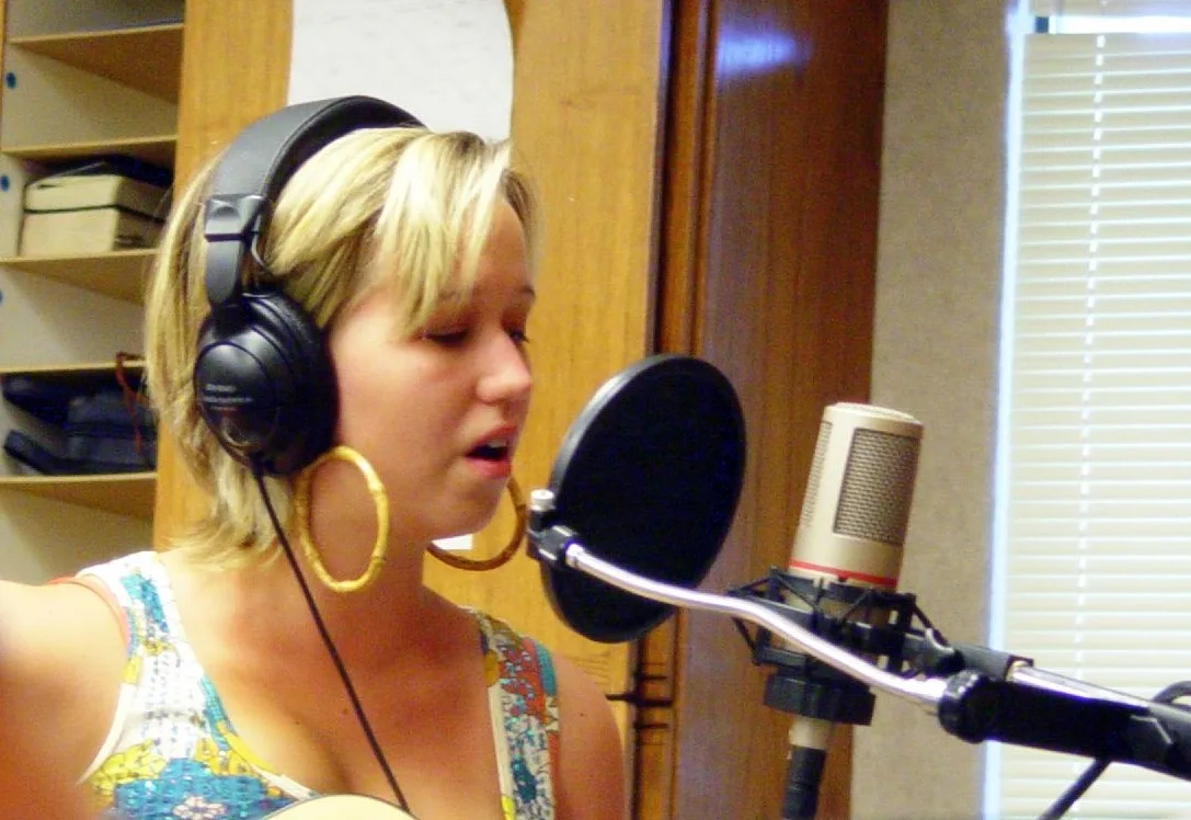 A singer in front of a pop filter and AKG C4000B microphone. Reading podcast production workflow with a sceptical eye