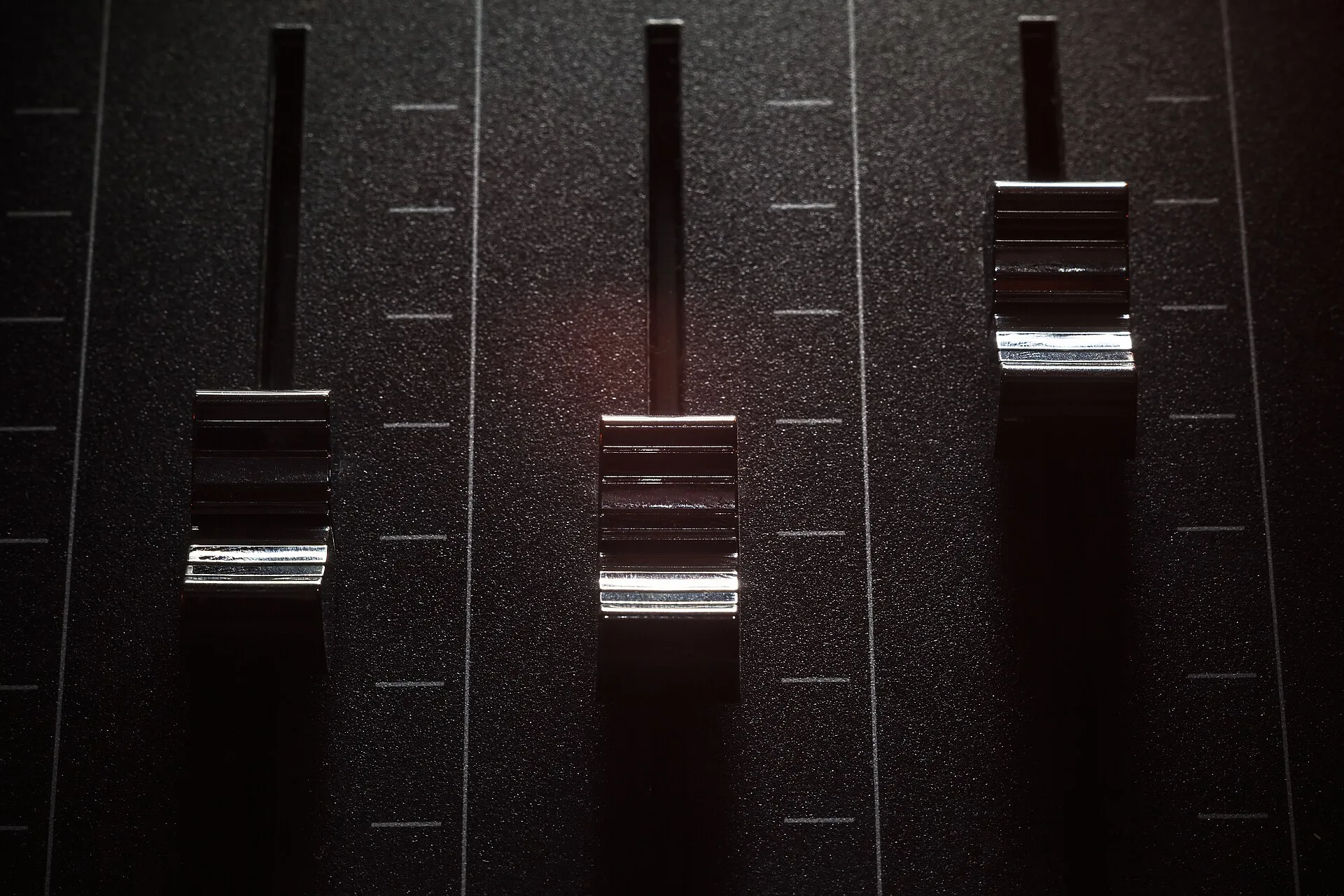 Details of faders of a mixing console, closeup view. Podcast sponsorship, one decision at a time