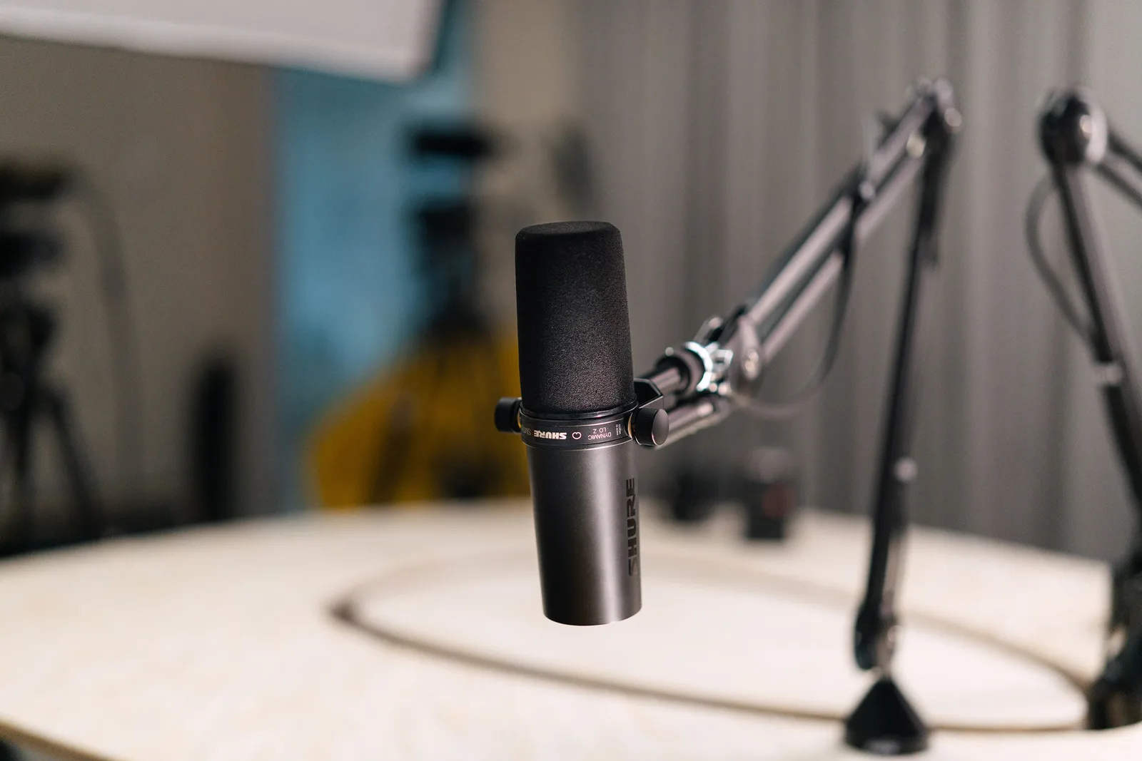 Close-up of a dynamic microphone in a professional studio setting. Podcast creator business: LLC setup in three states